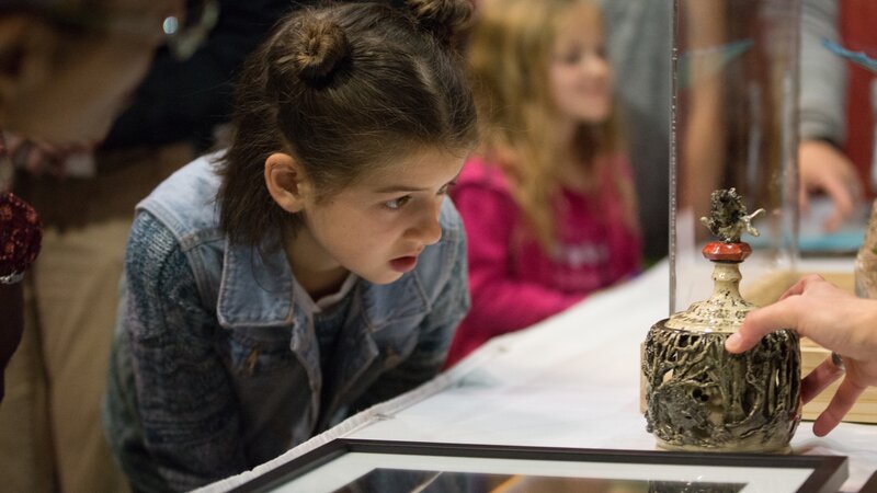 10th Annual Exhibit A youth attendee taking a closer look at the details of the Best of Show winning piece.