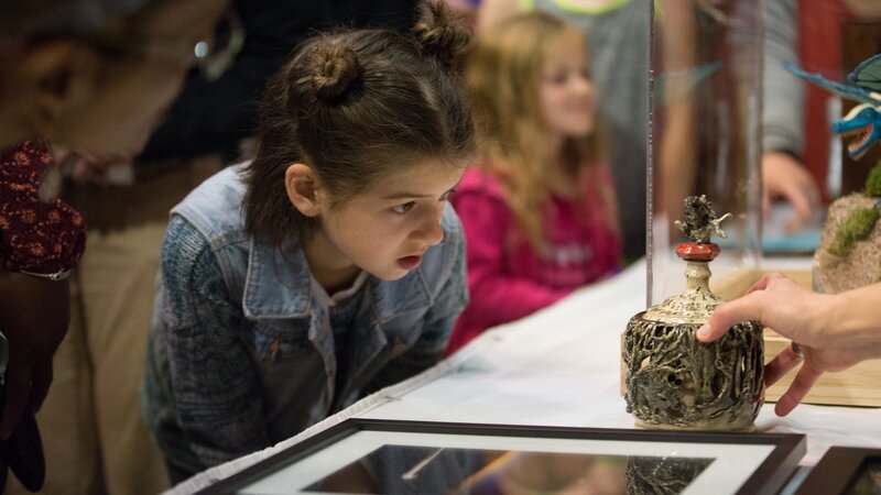 10th Annual Exhibit A youth attendee taking a closer look at the details of the Best of Show winning piece.