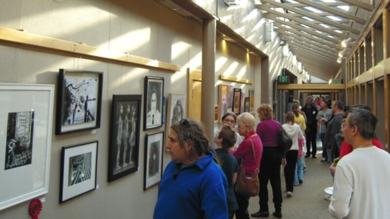 8th Annual Exhibit Attendees taking in the artwork on display at the Finley Community Center