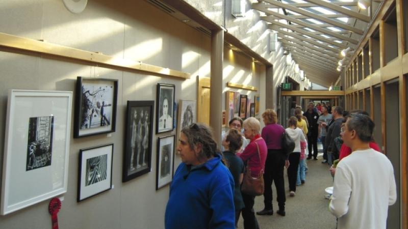 8th Annual Exhibit Attendees taking in the artwork on display at the Finley Community Center