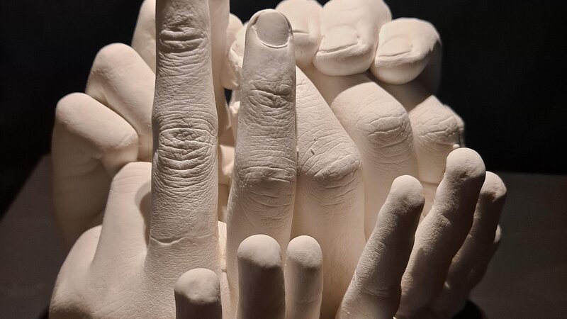 sculpture of many hands in different positions