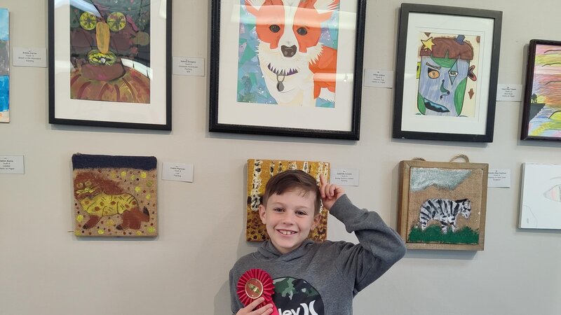 Colorful paper collage portrait of a dog with a collar on and blue background