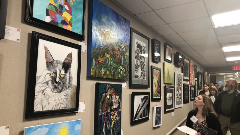 1st Annual Exhibit Attendees taking in the art at the first ever Huntsville Hospital Health System show.