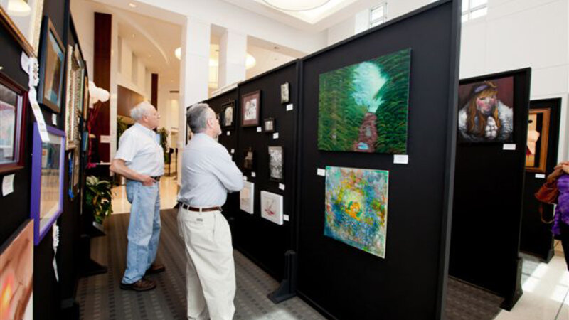7th Annual Exhibit Attendees to the 6th Annual NAP Exhibition at Atlantic Health Systems, NJ taking in some of the artwork made by very talented employees and their family members.