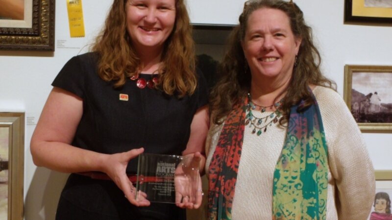 10th Annual Exhibit Venue Coordinator April Sullivan (L) proudly showing off her 10th Anniversary Award from the NAP with VSA Texas Executive Director Celia Hughes