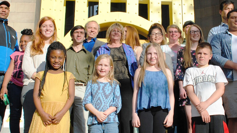 17th Annual Exhibit ARTwork winners pose in front of the Sister Bridge Replica parade float.