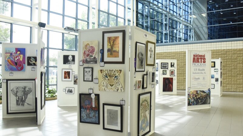 5th Annual Exhibit The Atrium of UF Health Jacksonville filled with vibrant art from this year's show.