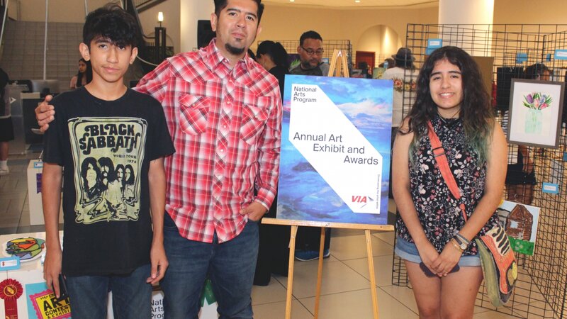 9th Annual Exhibit VIA employee Raul Pena poses with his children, Dean and Madison, who have all been participating artists in the NAP exhibit three years running.