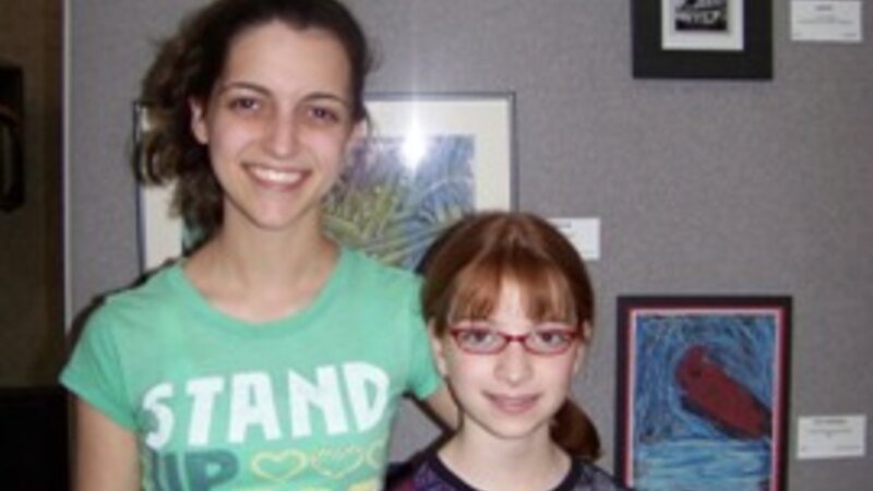 10th Annual Exhibit Sisters pose with their artwork