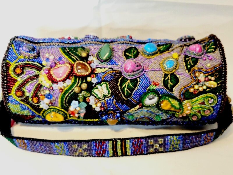 The purse is embroidered with beads using various natural semi-precious stones.