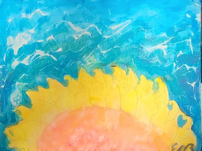 The sun blooming over the ocean