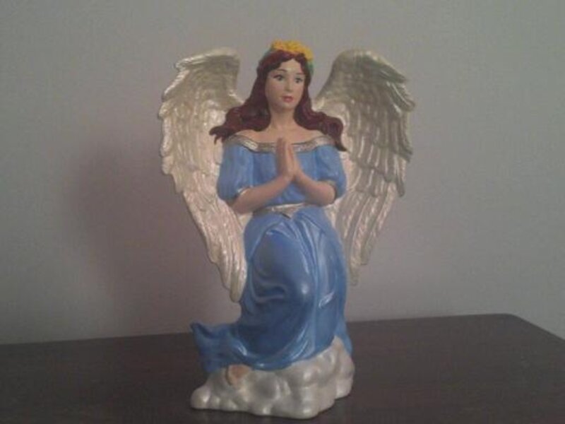 Angel kneeling in the clouds