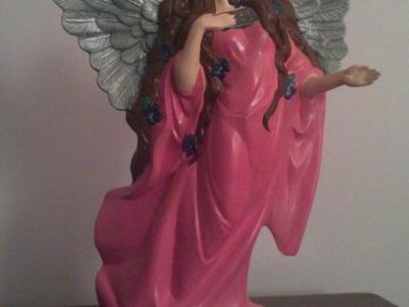 Angel standing with violets 