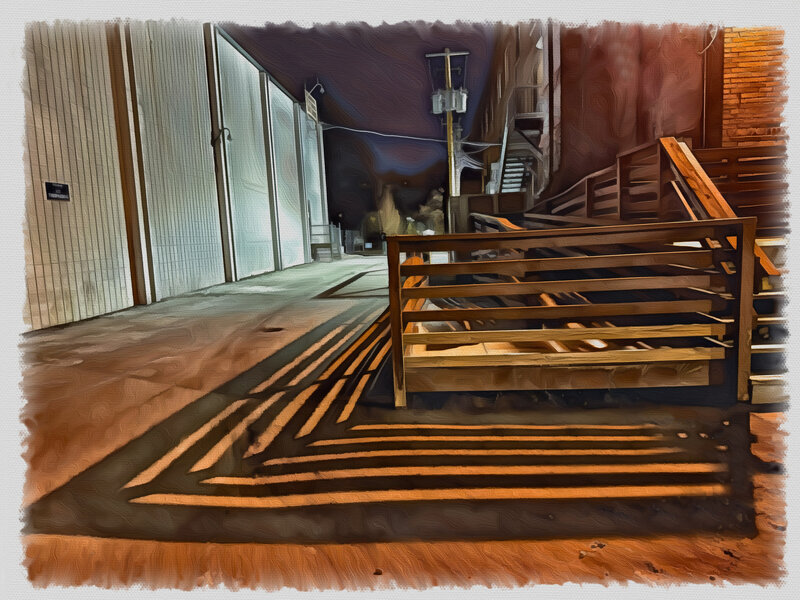 Shadows cast at night from the dock of an old warehouse.