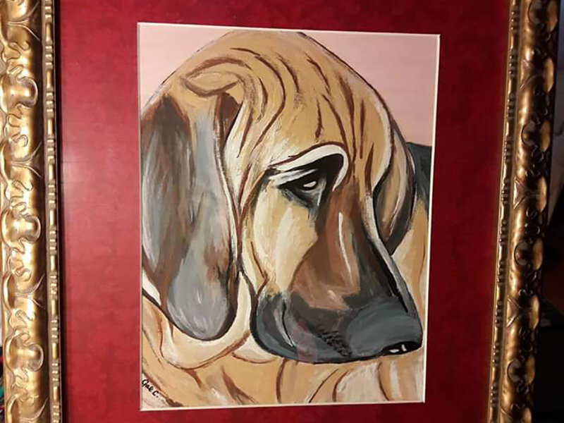 Canvas portrait of large hound dog with red matte and gold frame.