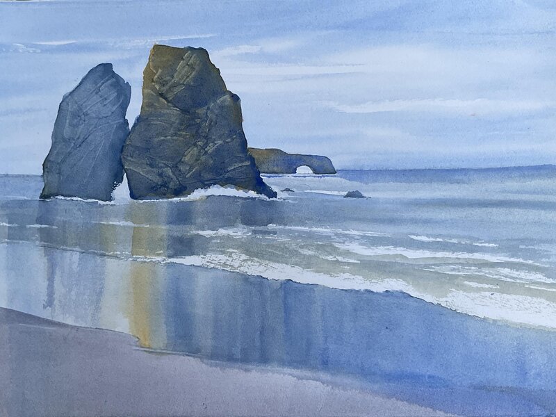 Sonoma coast depicting reflections of Split Rock in the wet sand.