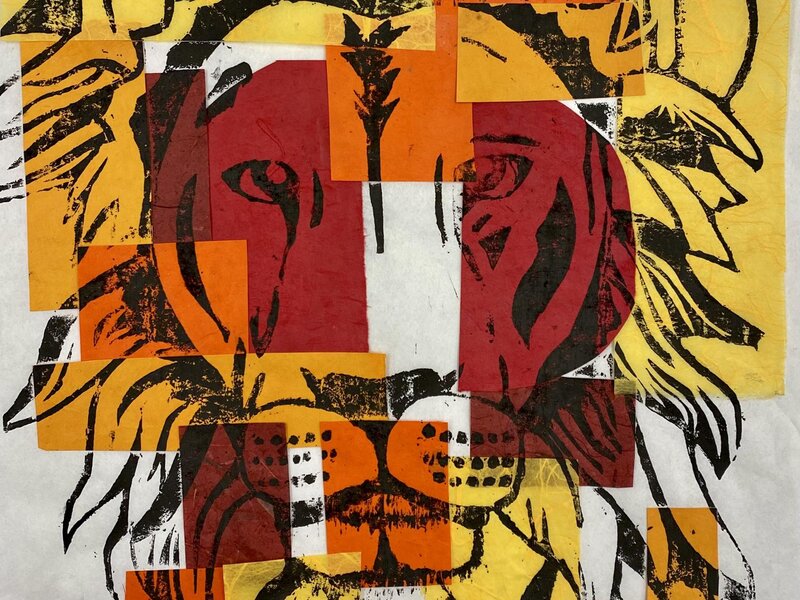Japanese Style WoodBlock Carving of a Lion profile printed with black ink on sheet of rice paper with pieces of warm colored paper on top.