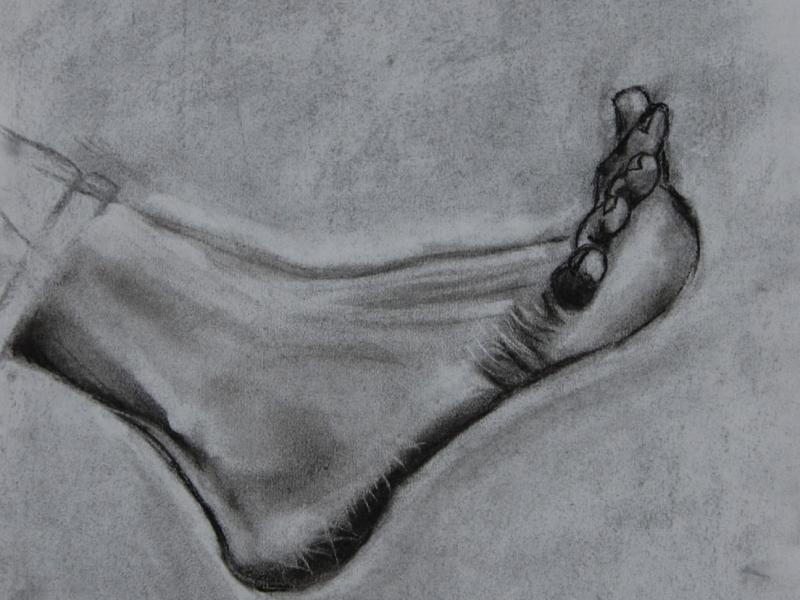 A charcoal drawing of a flexed foot.