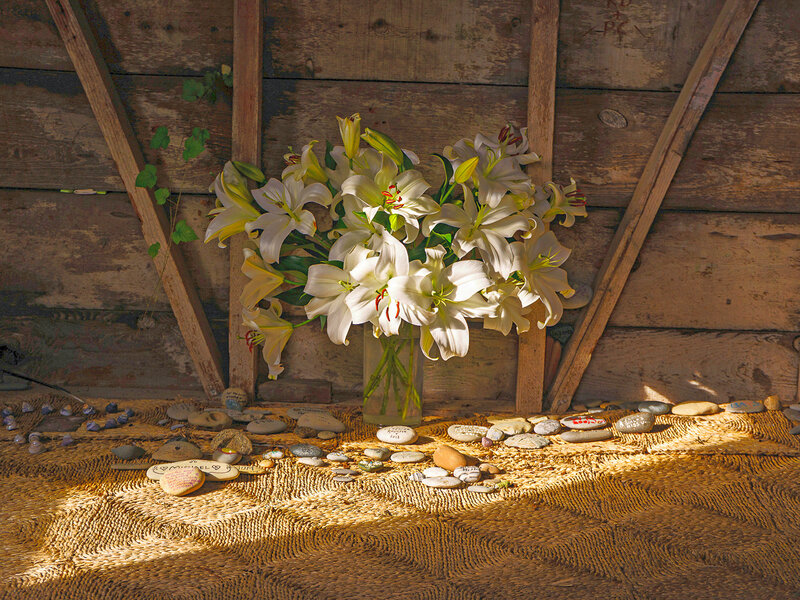 Lilies in a vase on a floor