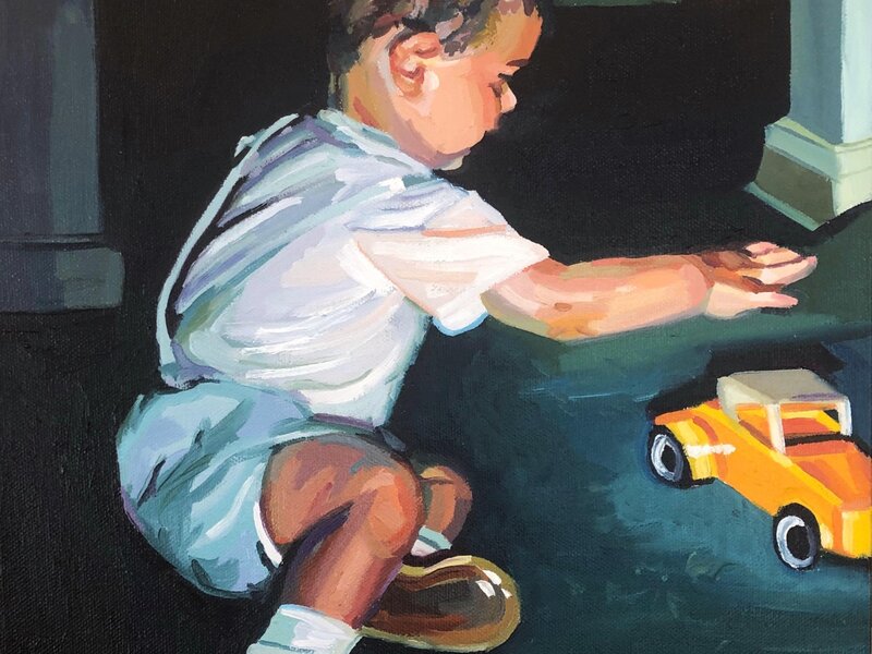 A mid century dressed two year old boy reaching for a yellow toy car. There is strong lighting with a black and dark green room background. 
