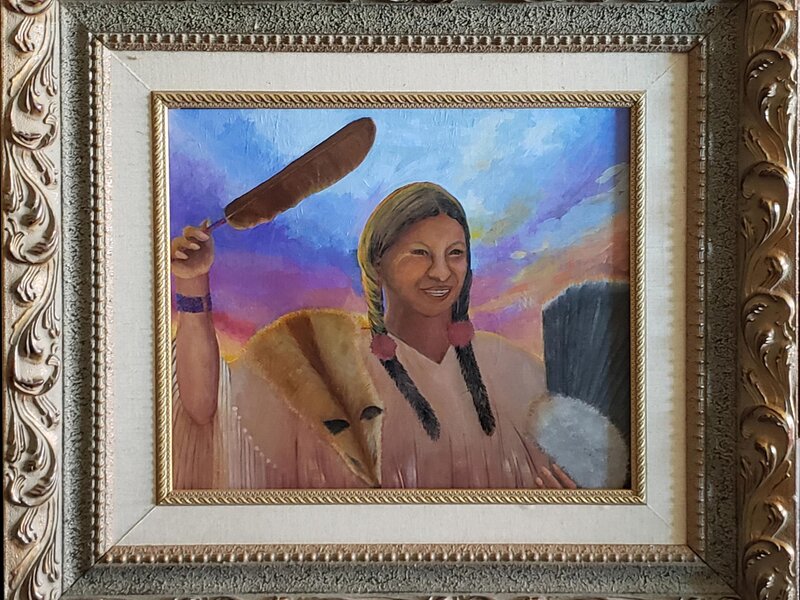 The Healer raises her sacred feather to bless the sunrise dancers