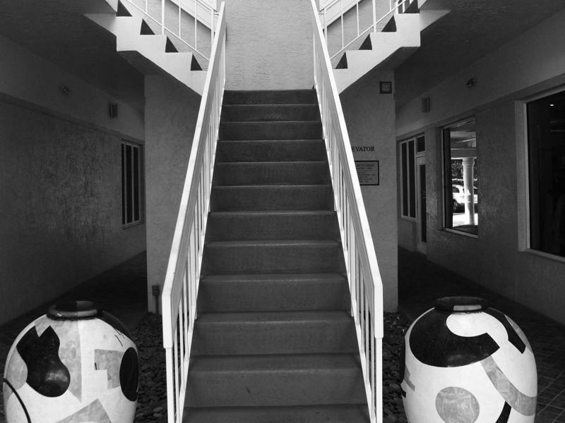 Stairway in Naples Florida and two large urns