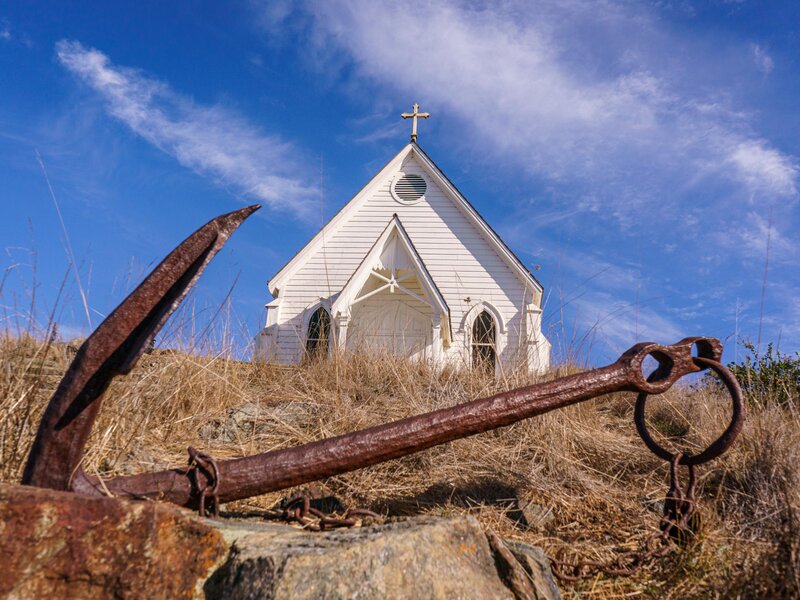 White church, rusted anchor
