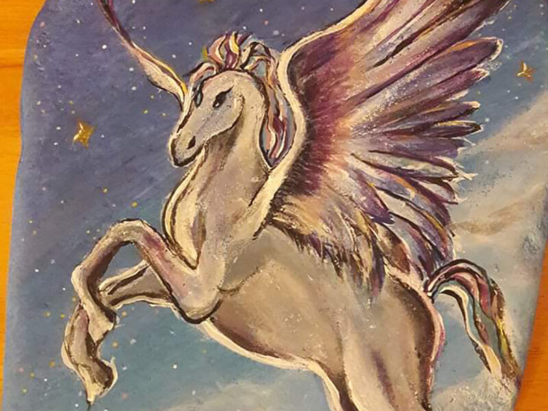 Fantasy Pegasus flying among the clouds and stars.
