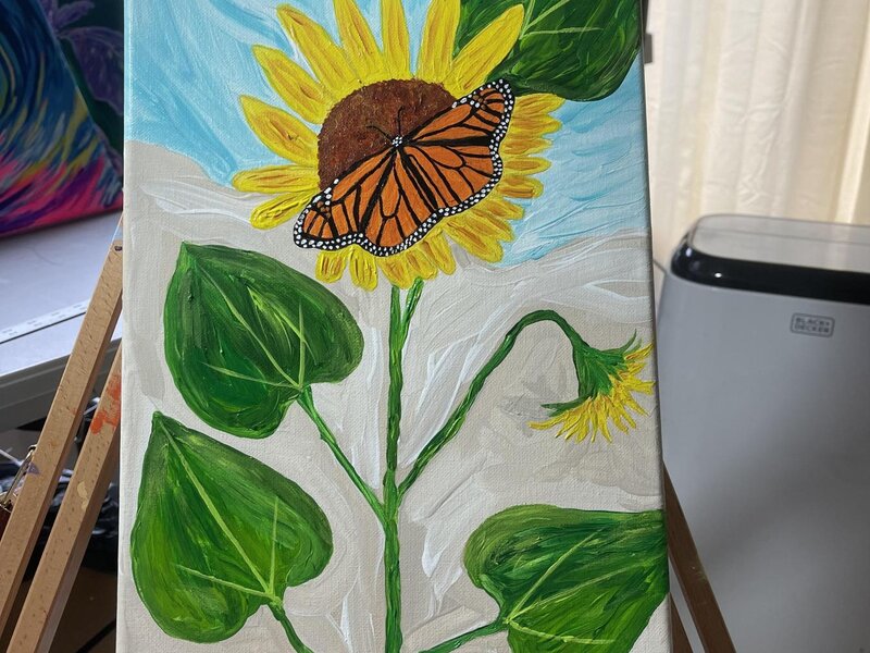 Sunny day sunflower with monarch butterfly in the middle