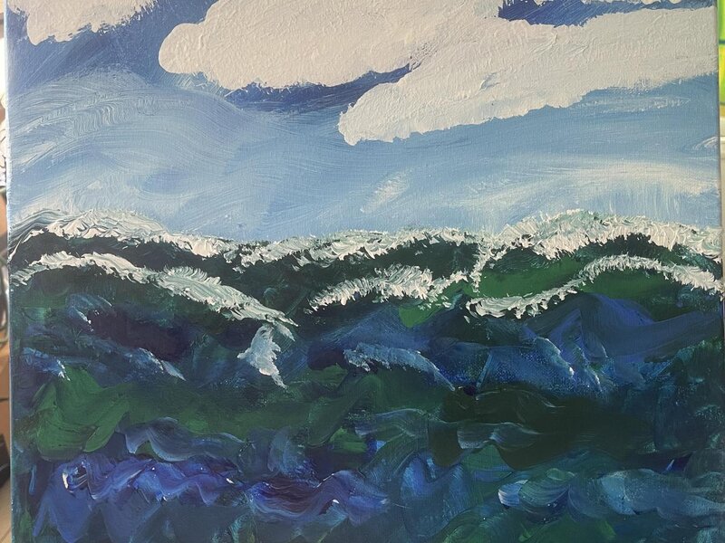 Cloudy sky with wild waves rolling 