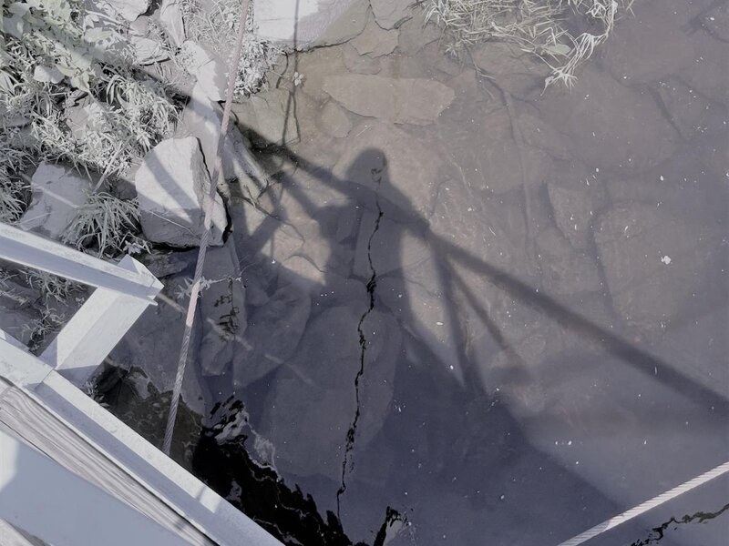 reflection of a person looking down into water