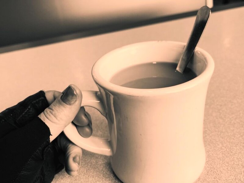 a cup of coffee on a diner table