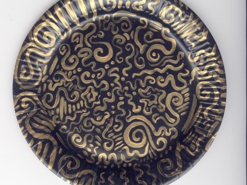 detail of black and gold plate in Dutch Paper Plate Installation