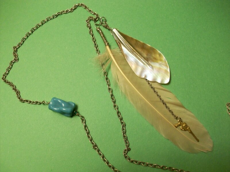 Pink feather necklace with gun charm and shell 