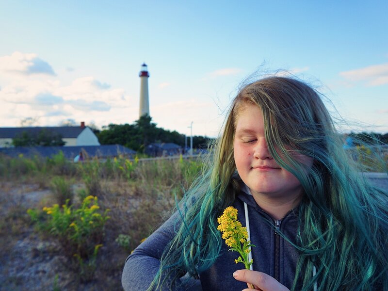 lighthouse, hair, goldenrod, sunset, flowers, girl, clouds, cape may