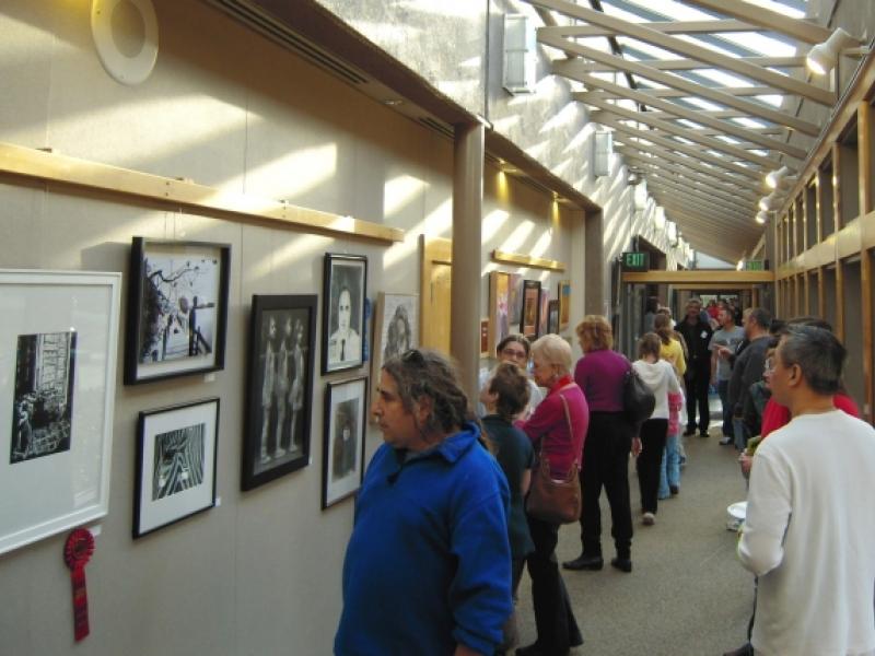 8th Annual Exhibit Attendees taking in the artwork on display at the Finley Community Center
