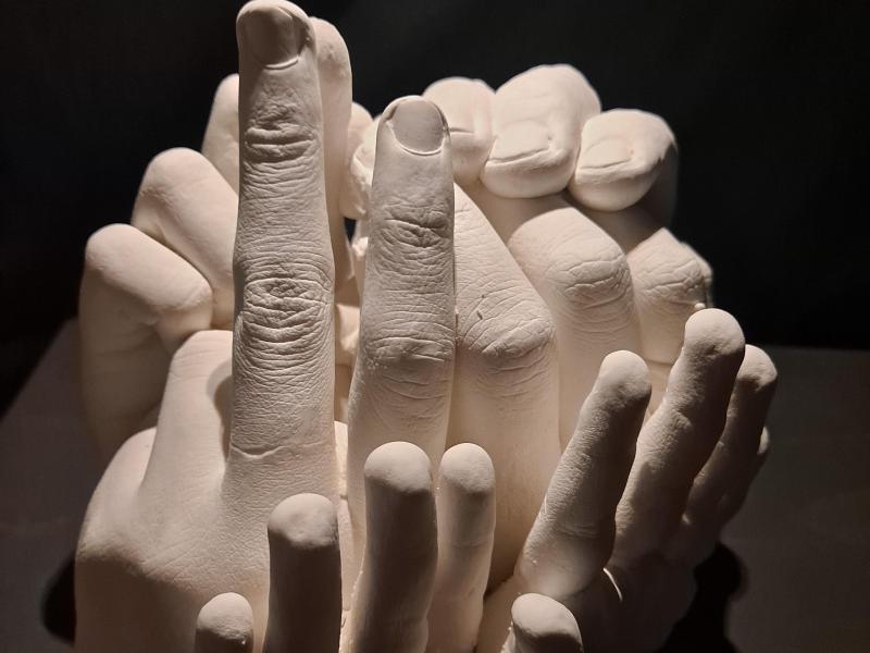 sculpture of many hands in different positions