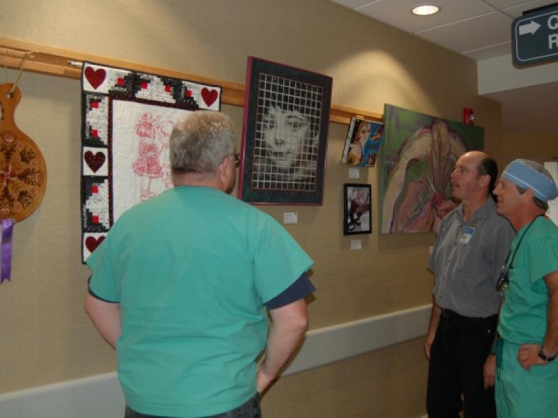 2nd Annual Exhibit Employees of the hospital stop to discuss the artwork on display