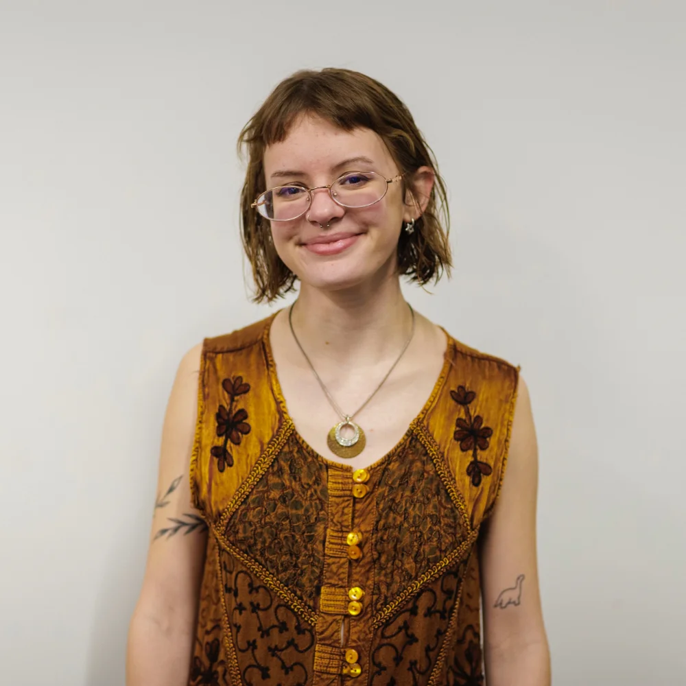 Photo of a young woman with glasses and short hair.