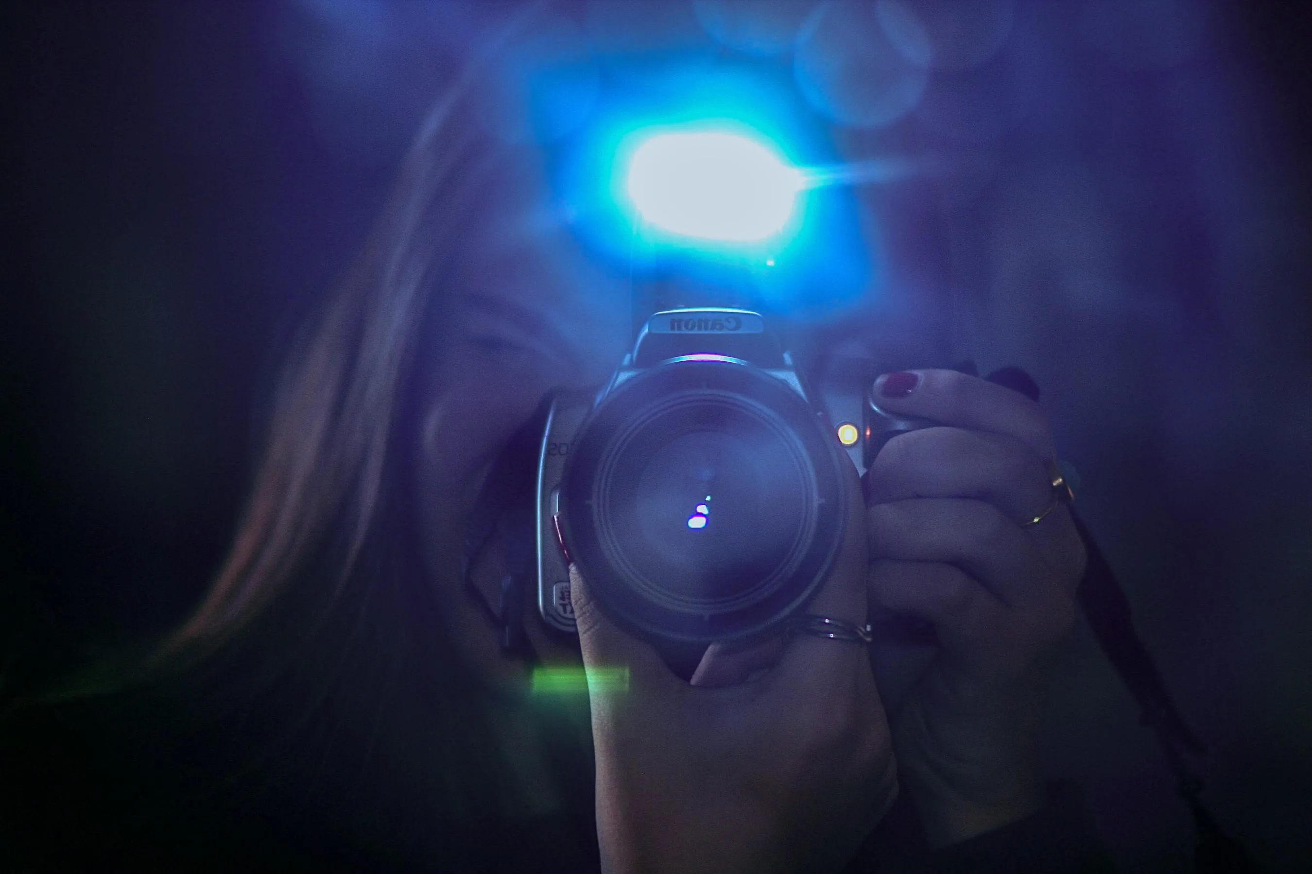 A picture of me holding my camera through a mirror 