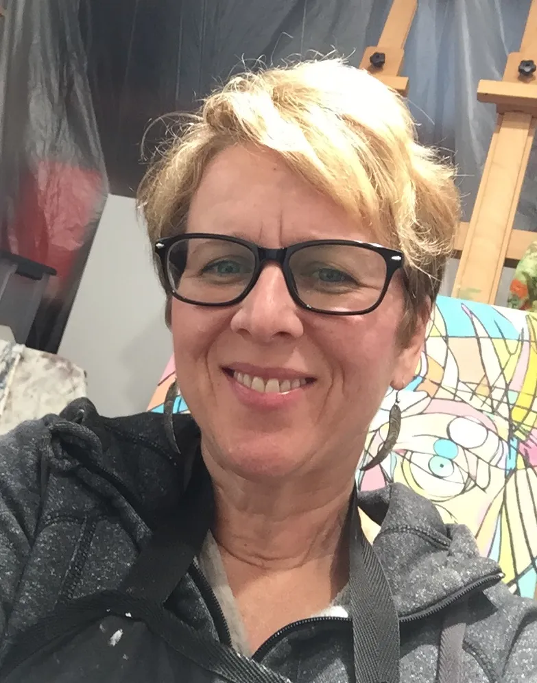 Portrait of woman with short blonde hair and black framed glasses