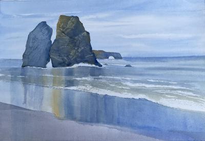 Sonoma coast depicting reflections of Split Rock in the wet sand.