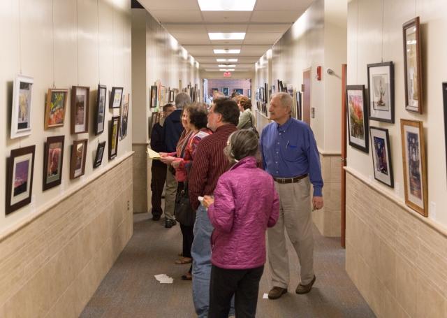 9th Annual Exhibit Attendees browsing the artwork filled hallways of the Regional Emergency Training Center at Camden County College