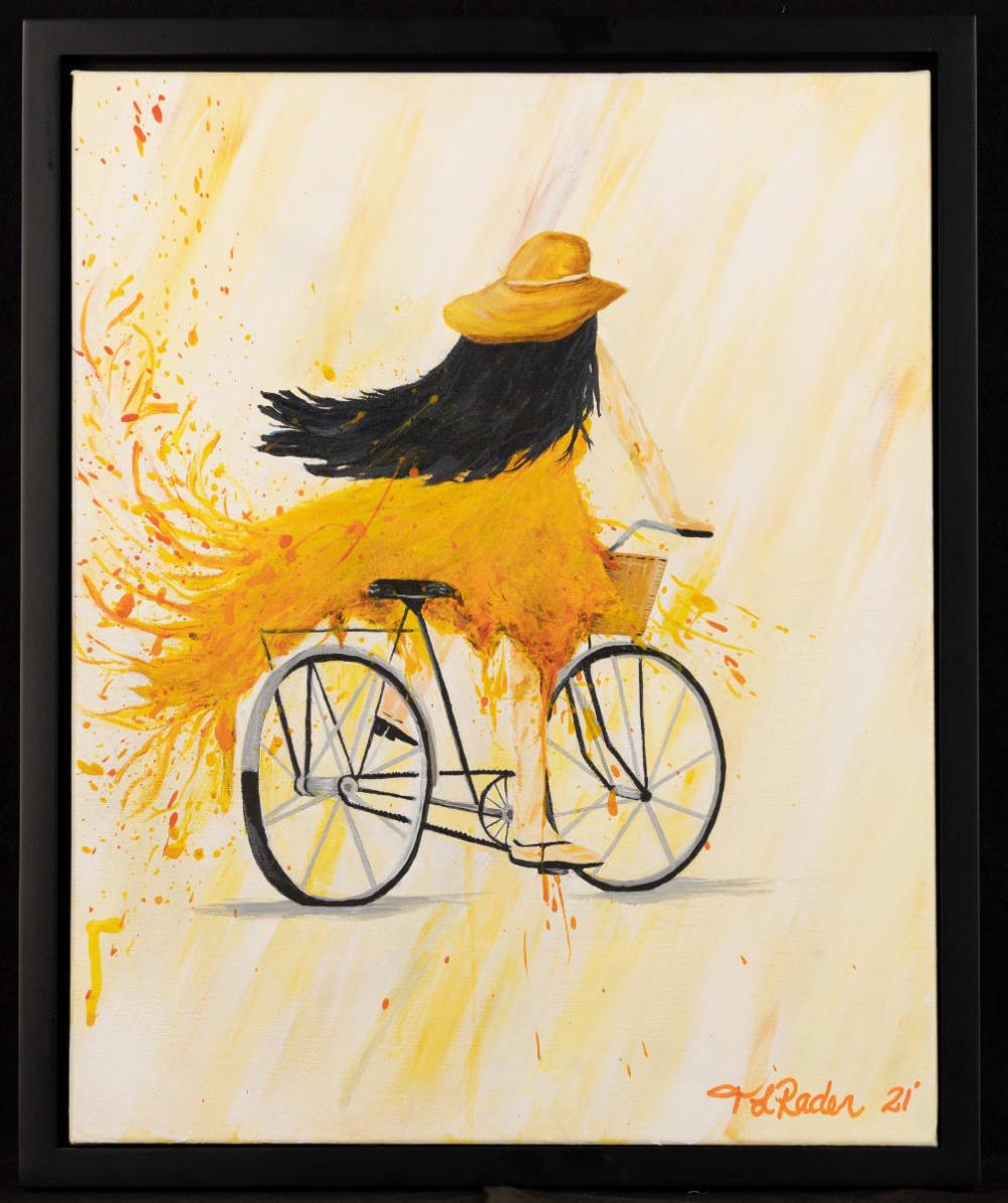 a girl riding a bike with a flowing yellow dress
