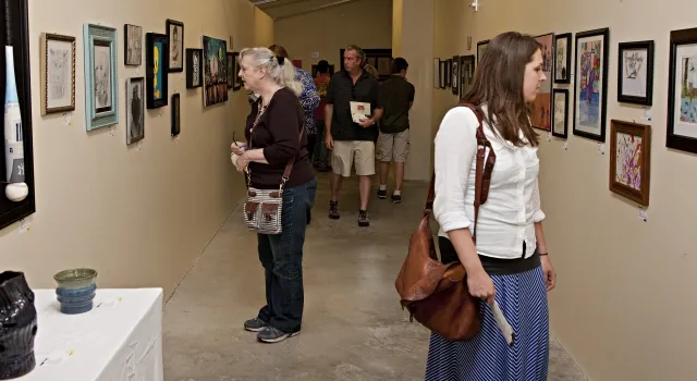 4th Annual Exhibit Attendees taking in the employee artwork on display at the Avera Prairie Center.