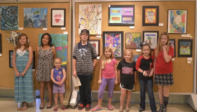 23rd Annual Exhibit Youth participants posing with their artwork at the awards reception in Lubbock, TX.