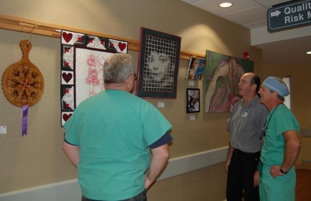 2nd Annual Exhibit Employees of the hospital stop to discuss the artwork on display