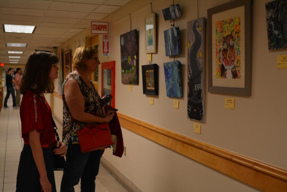 15th Annual Exhibit Attendees taking in the artwork at the Seminole County Services Building