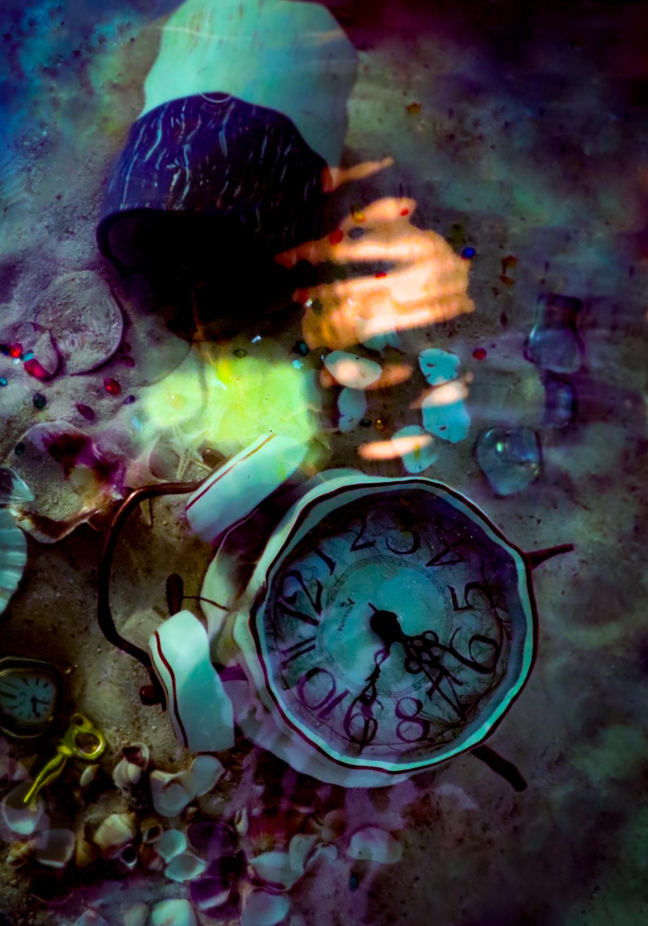 Clock sits on the bottom of the ocean surrounded by sand and treasures lost in time. 