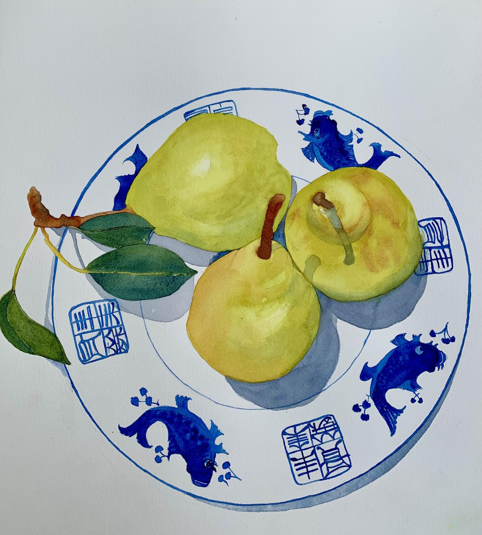 3 yellow pears on a white dish with blue koi pattern